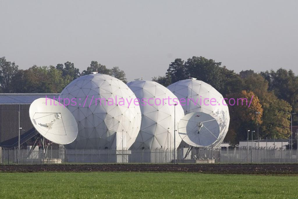 Three large satellite dishes with radome covers.