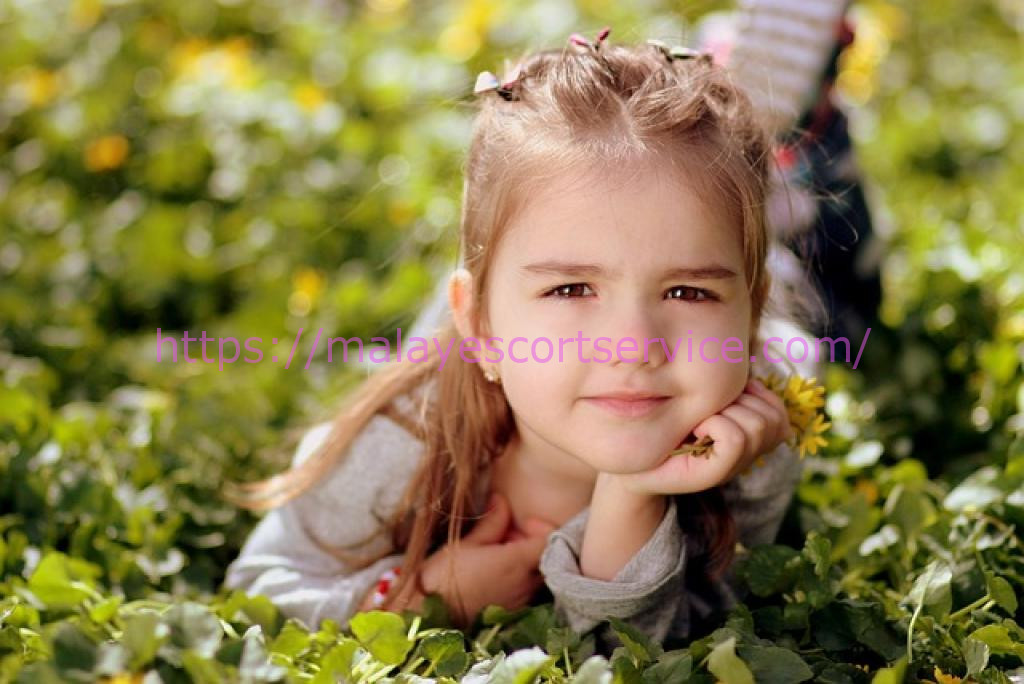Adorable girl lying in a field of flowers.