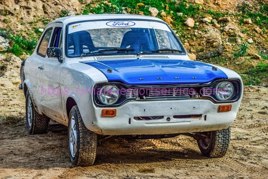 Vintage Ford Escort rally car on dirt road